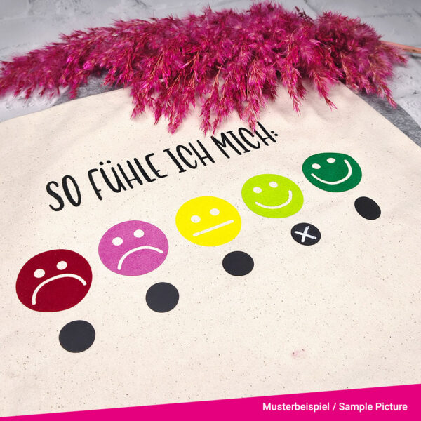Colourful smileys are plotted on a bag. Underneath is a chalkboard area which you can tick.